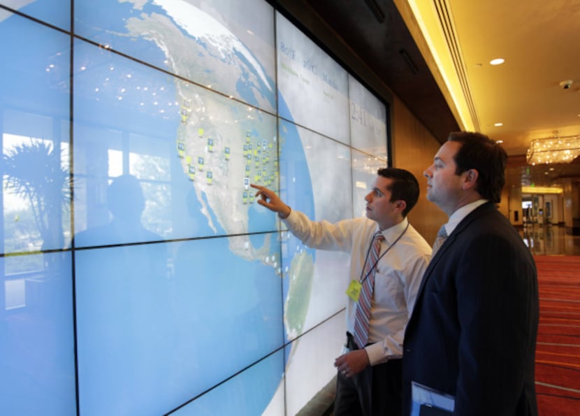 Deloitte executives Dave Brod (left) and Jason Downing demonstrate the media wall at...