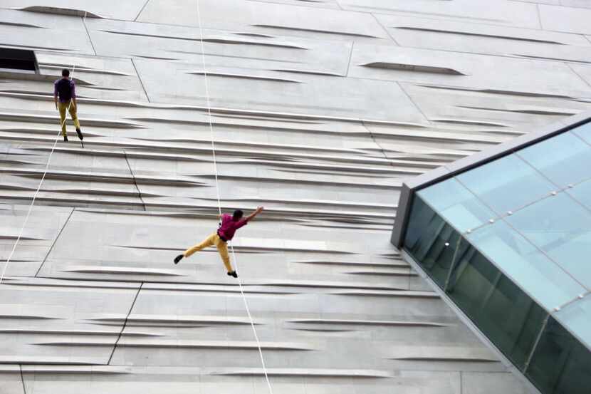 BANDALOOP, which performed on the side of the Perot Museum of Nature and Science in 2013,...