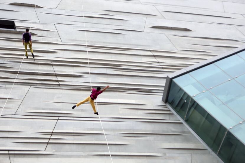 BANDALOOP, which performed on the side of the Perot Museum of Nature and Science in 2013,...