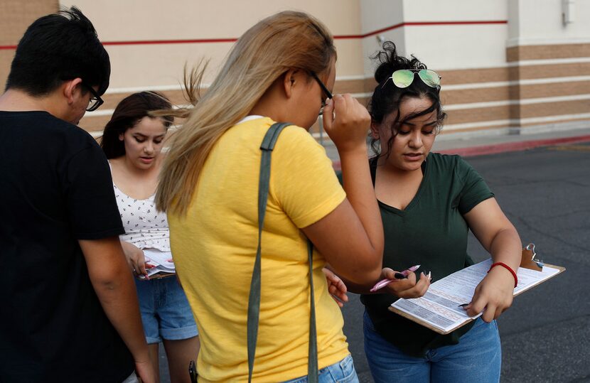 Maria Nieto (right) and Alma Romo (second from left) registered people to vote in Las Vegas...