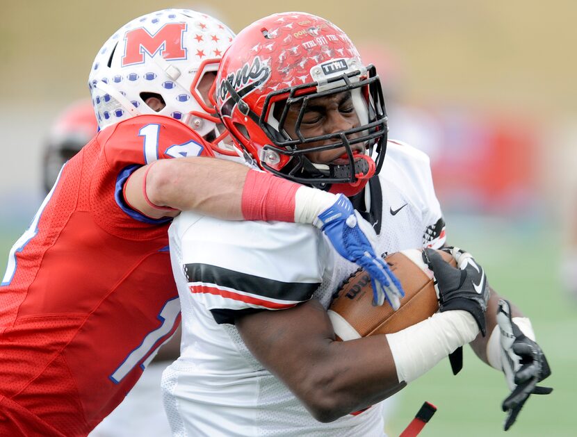 Cedar Hill's Larry Hill runs through a tackle attempt by Waco Midway's Keith Efferson (14)...