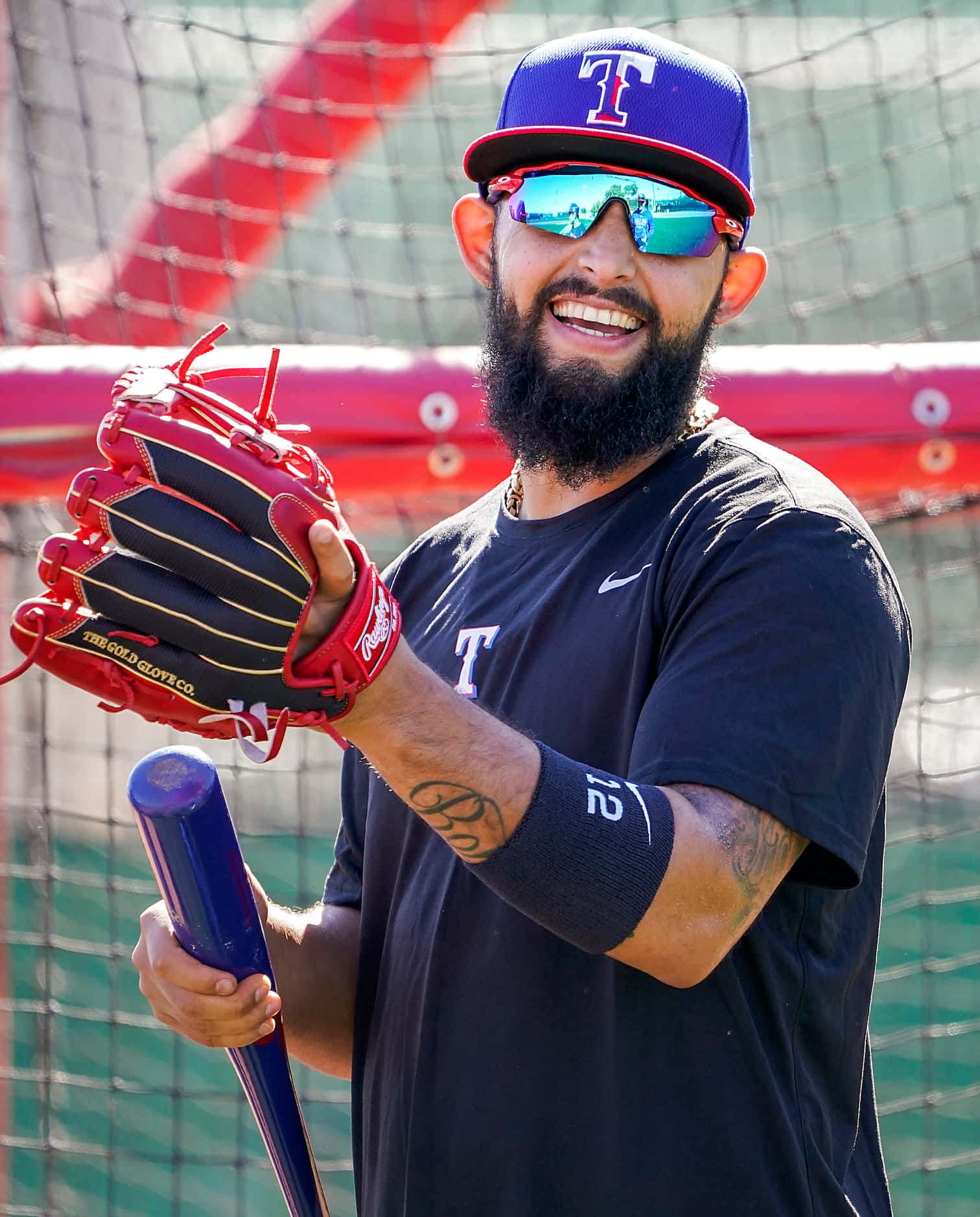 Texas Rangers second baseman Rougned Odor laughs with teammates during a spring training...
