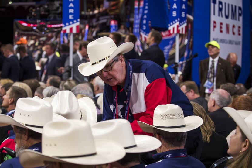 Texas Lt. Gov. Dan Patrick huddled with fellow state delegates Monday during an effort by...