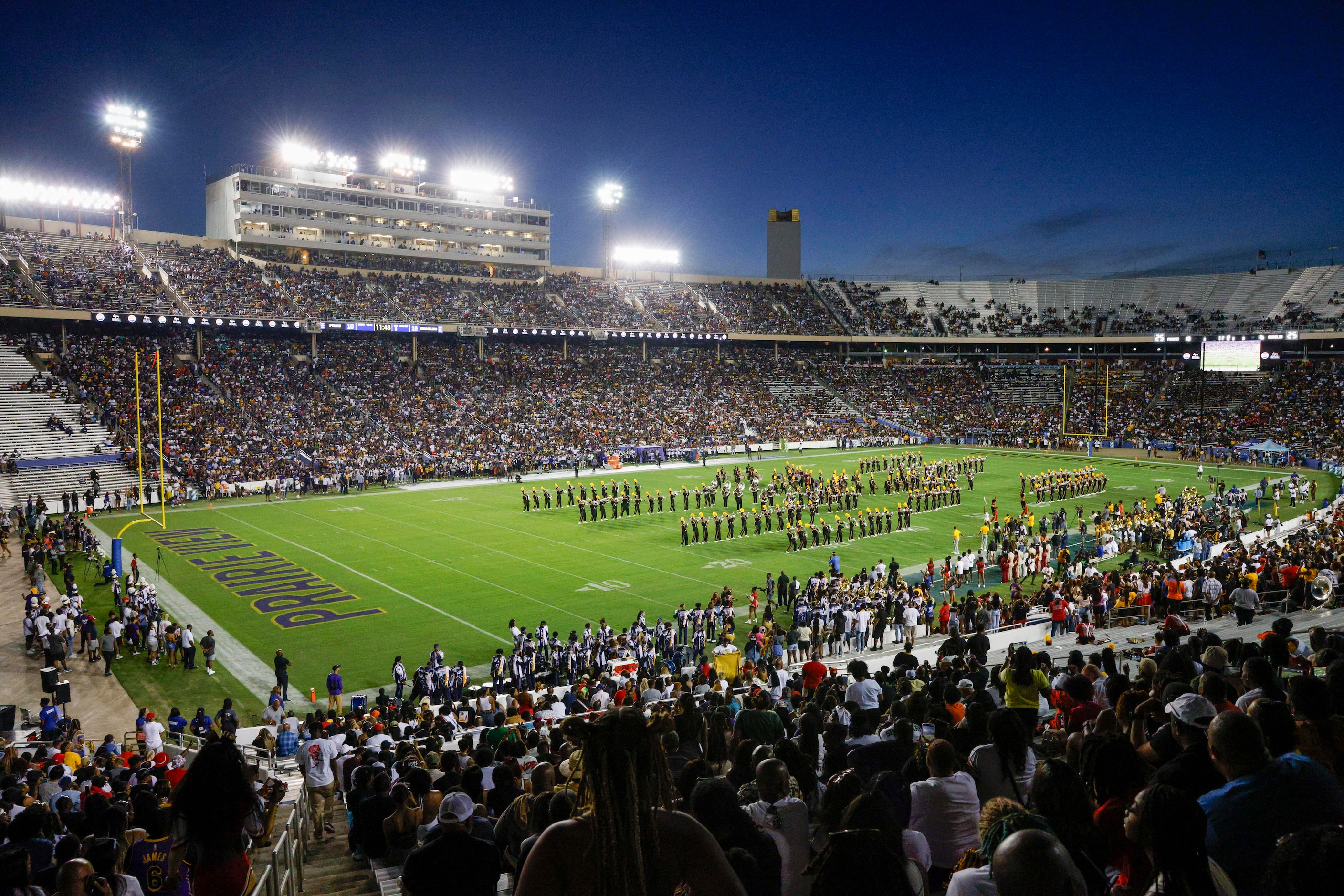 Fans watch as the Grambling State marching band performs during halftime at the State Fair...