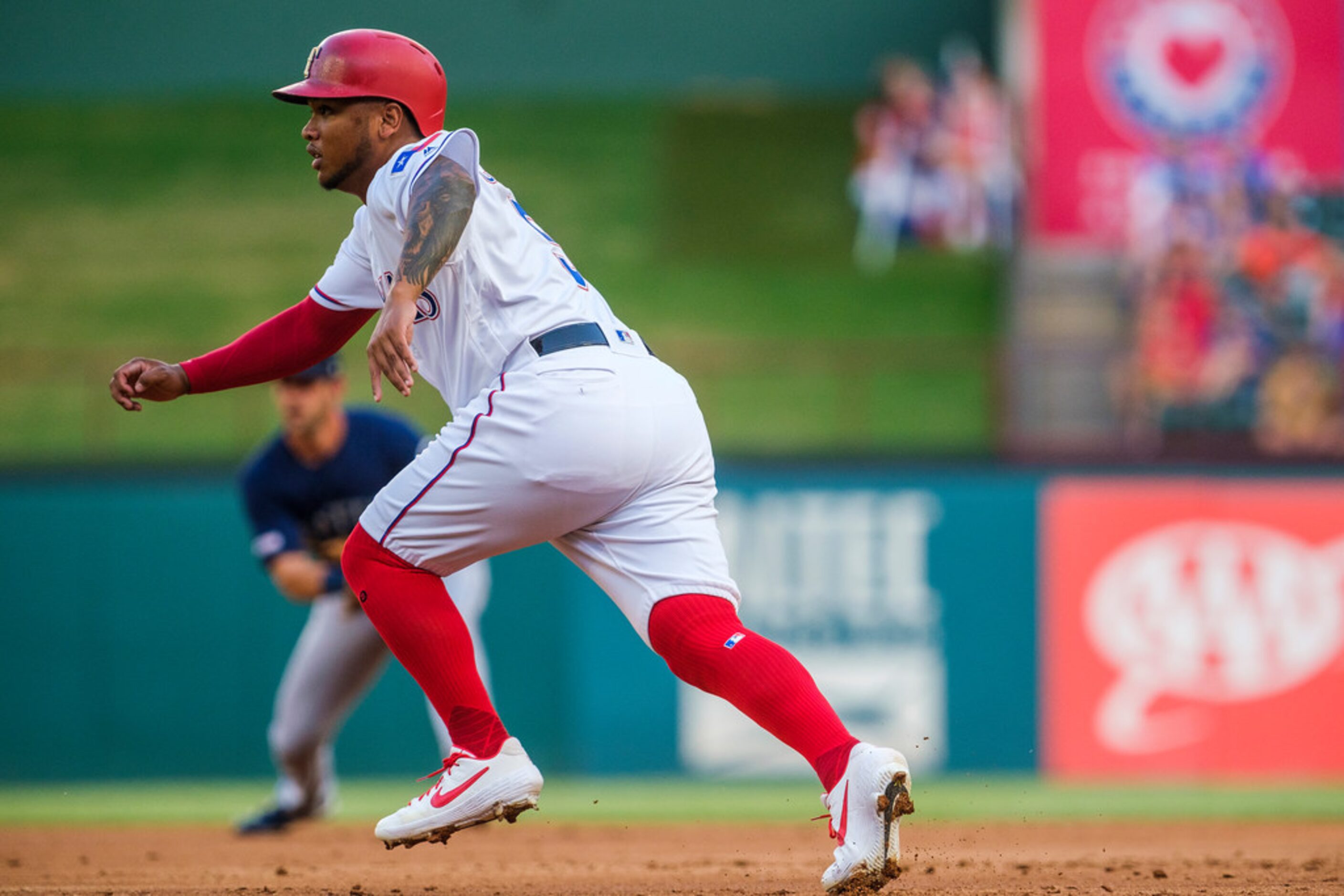 Texas Rangers left fielder Willie Calhoun takes a lead off first base during the second...