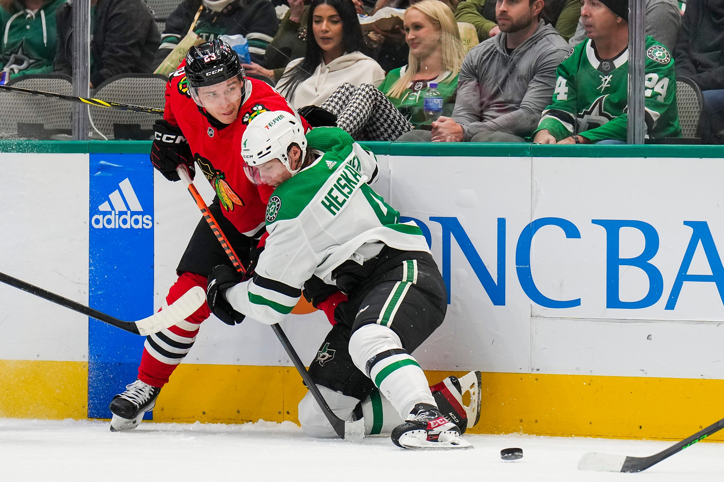 Dallas Stars defenseman Miro Heiskanen (4) ties up Chicago Blackhawks center Philipp...