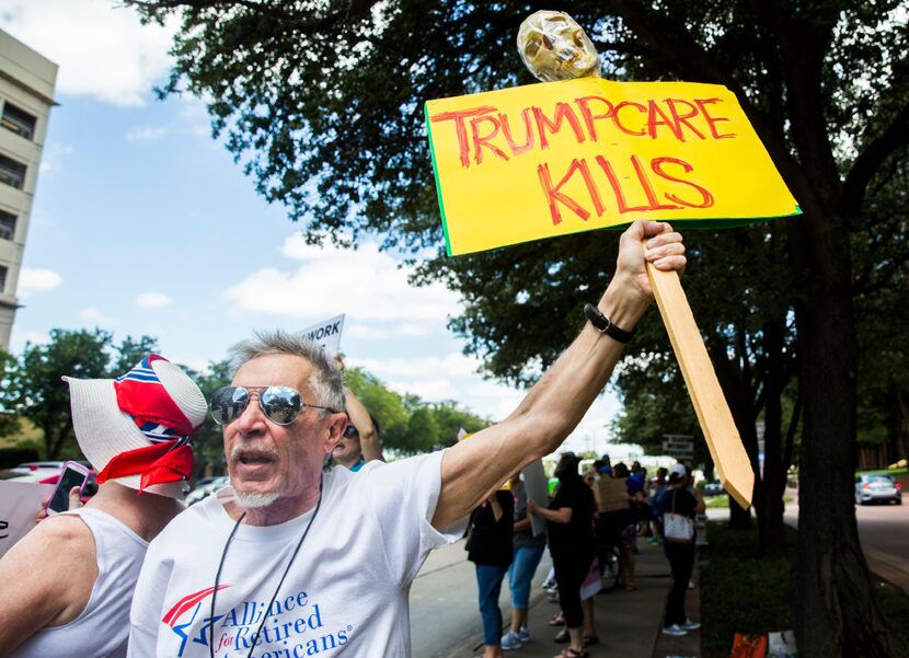 Zen Biasco of Chicago protests at a rally against the latest health care bill in front of...