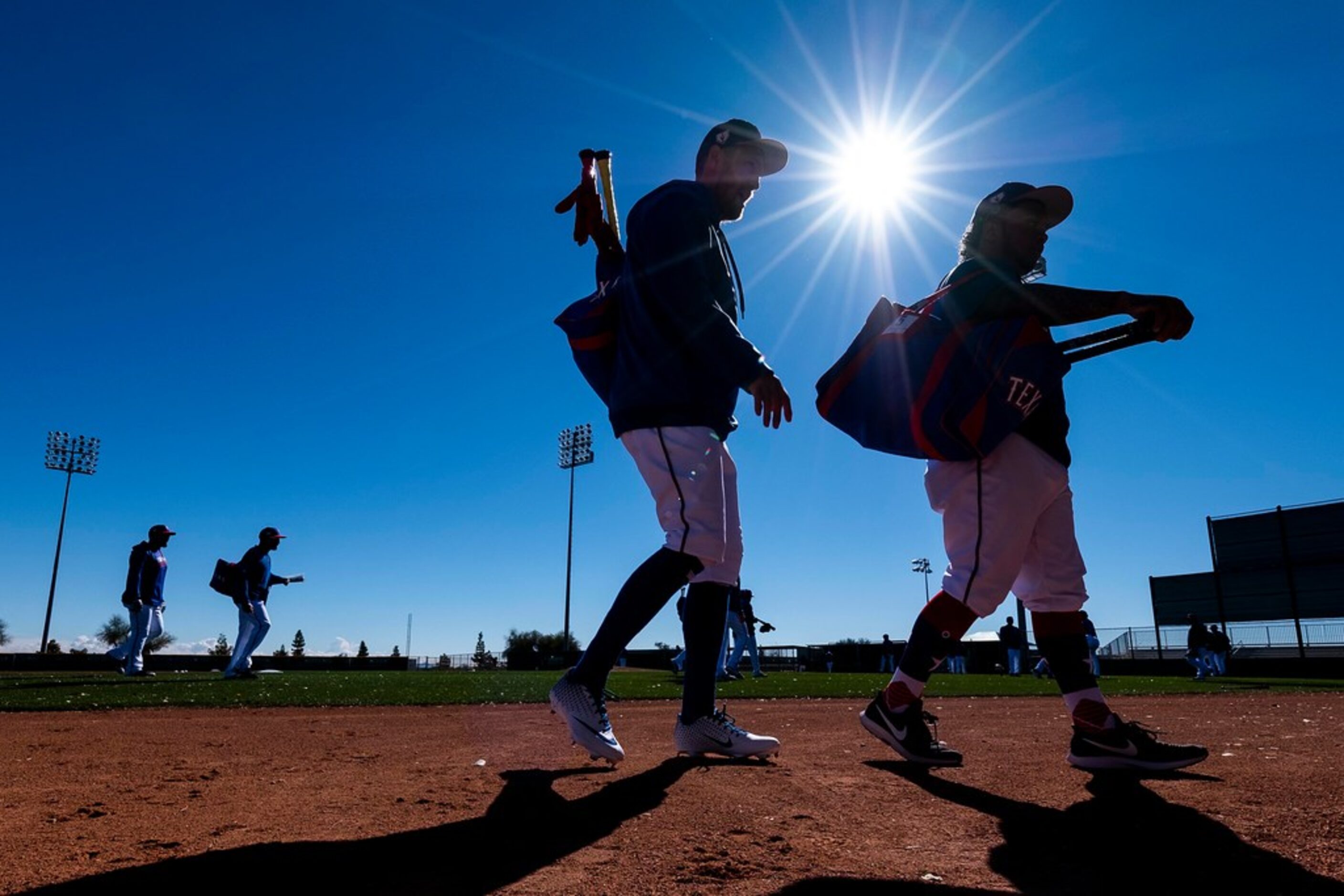 Texas Rangers outfielders Hunter Pence (center) and Willie Calhoun (right) take the field...