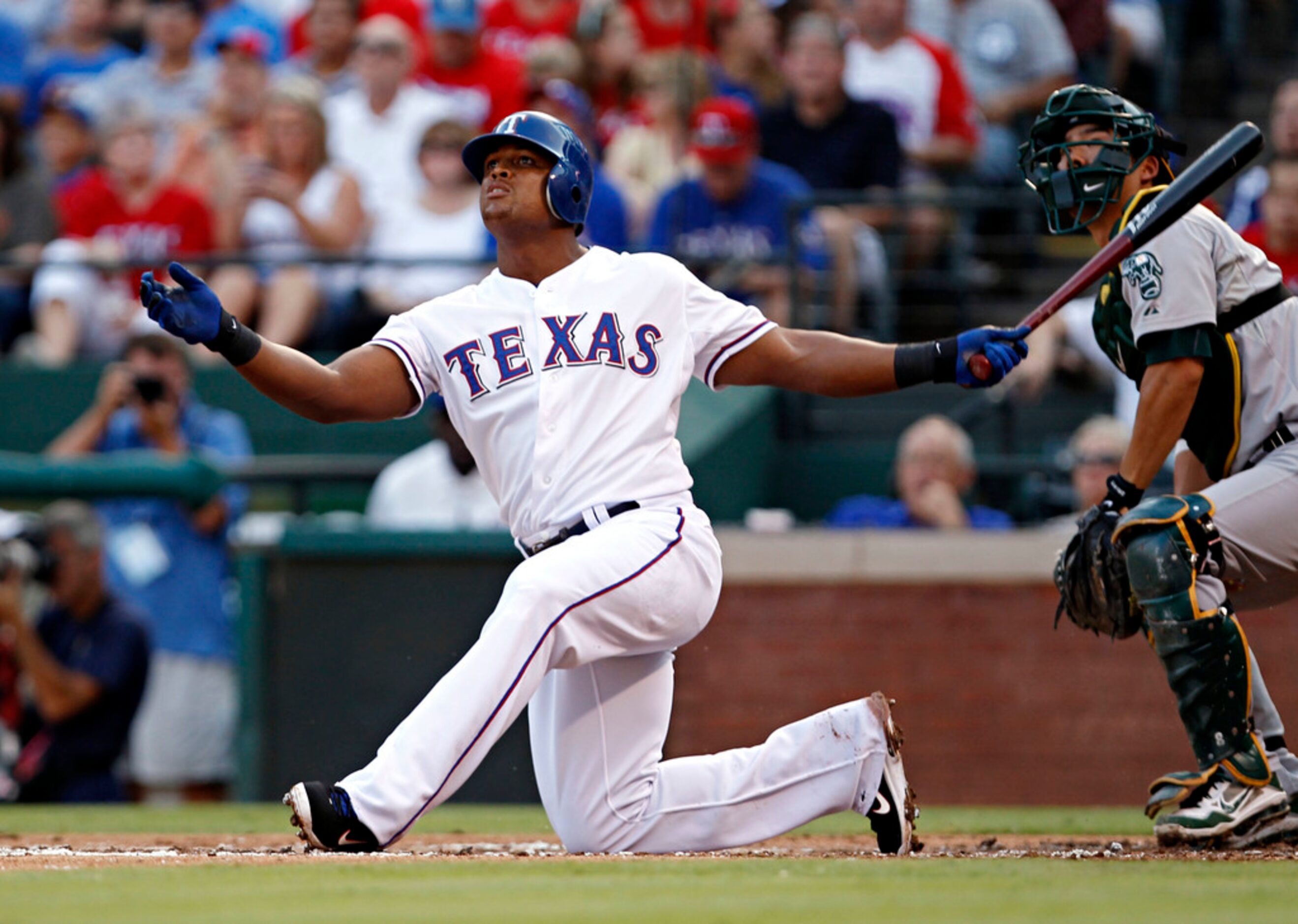 Texas Rangers third baseman Adrian Beltre ends up on his knees after a foul at the hands of...