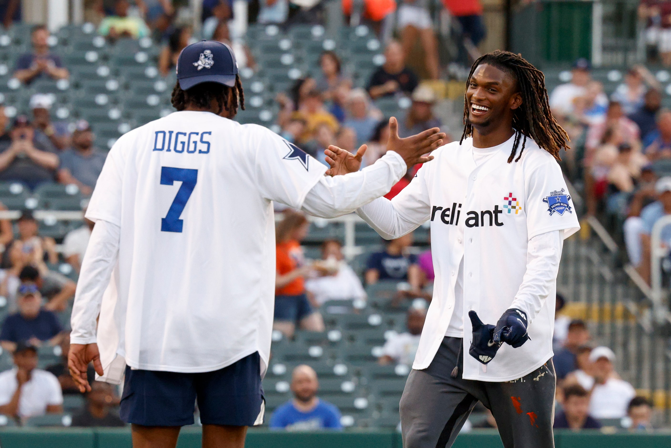 Dallas Cowboys cornerback Trevon Diggs high-fives wide receiver CeeDee Lamb during the...