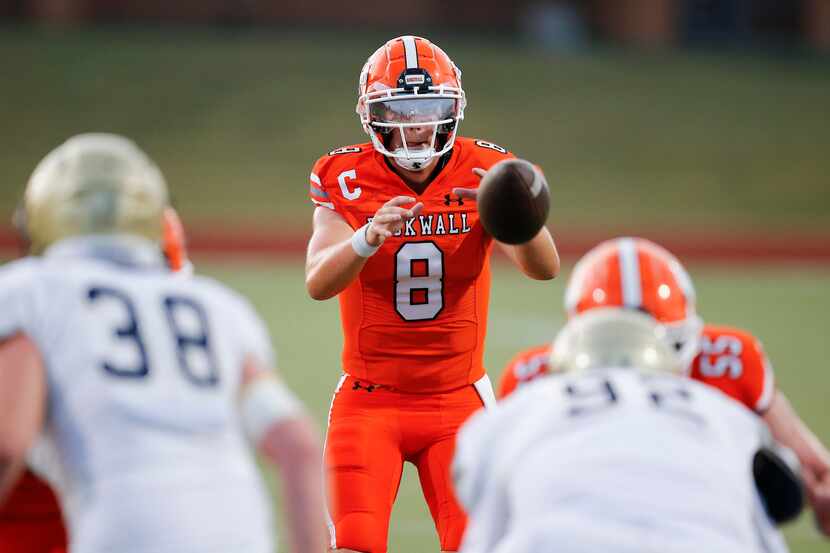 Rockwall senior quarterback Braedyn Locke (8) catches the snap during the first half of a...