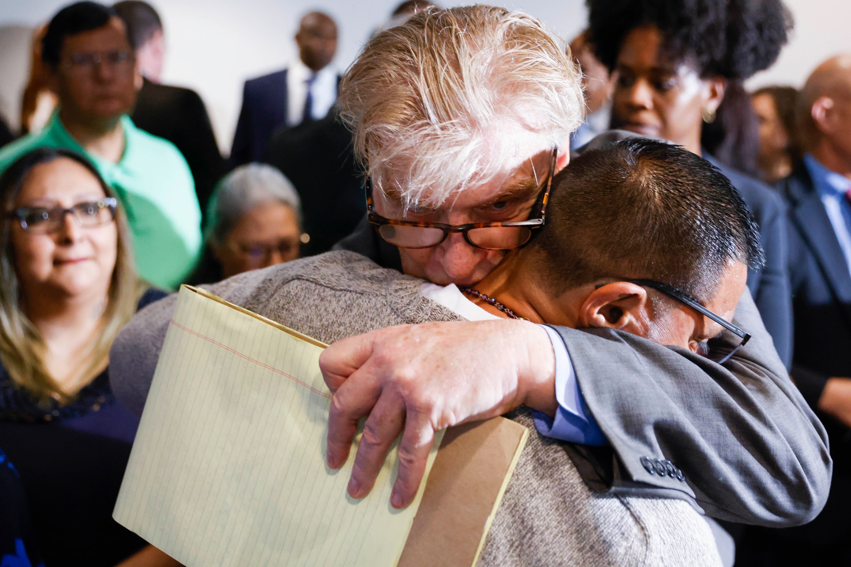 Defense attorney Paul Casteleiro (center), legal director of Centurion Ministries Inc., hugs...