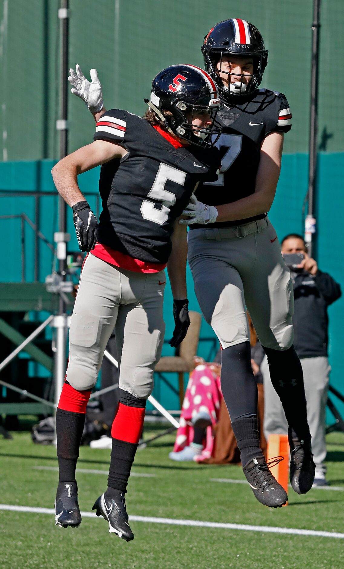 Lovejoy High School wide receiver Bo Allen (5) leaps into the air to congratulate Lovejoy...