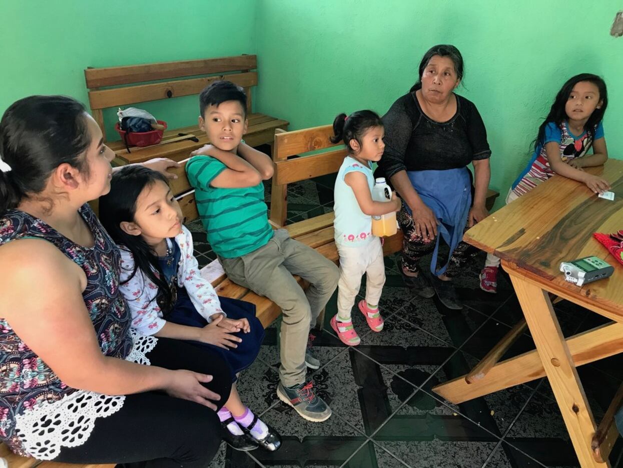 Martina Alvarez sits with her grandchildren and daughter in-law, Clara Vielman, in their...