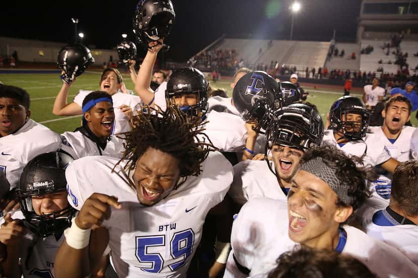 Hebron offensive lineman Chancellor Shepard (59) and his teammates celebrate after earning a...