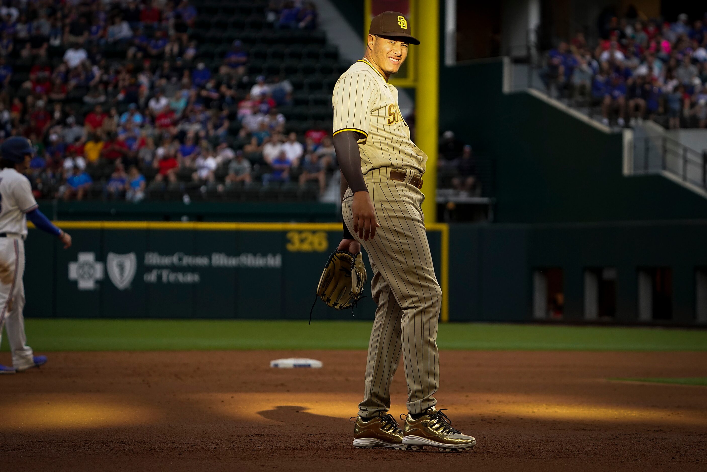 San Diego Padres third baseman Manny Machado squints as sunlight streams across his position...