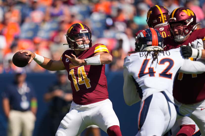 Washington Commanders quarterback Sam Howell looks to pass against the Denver Broncos in the...