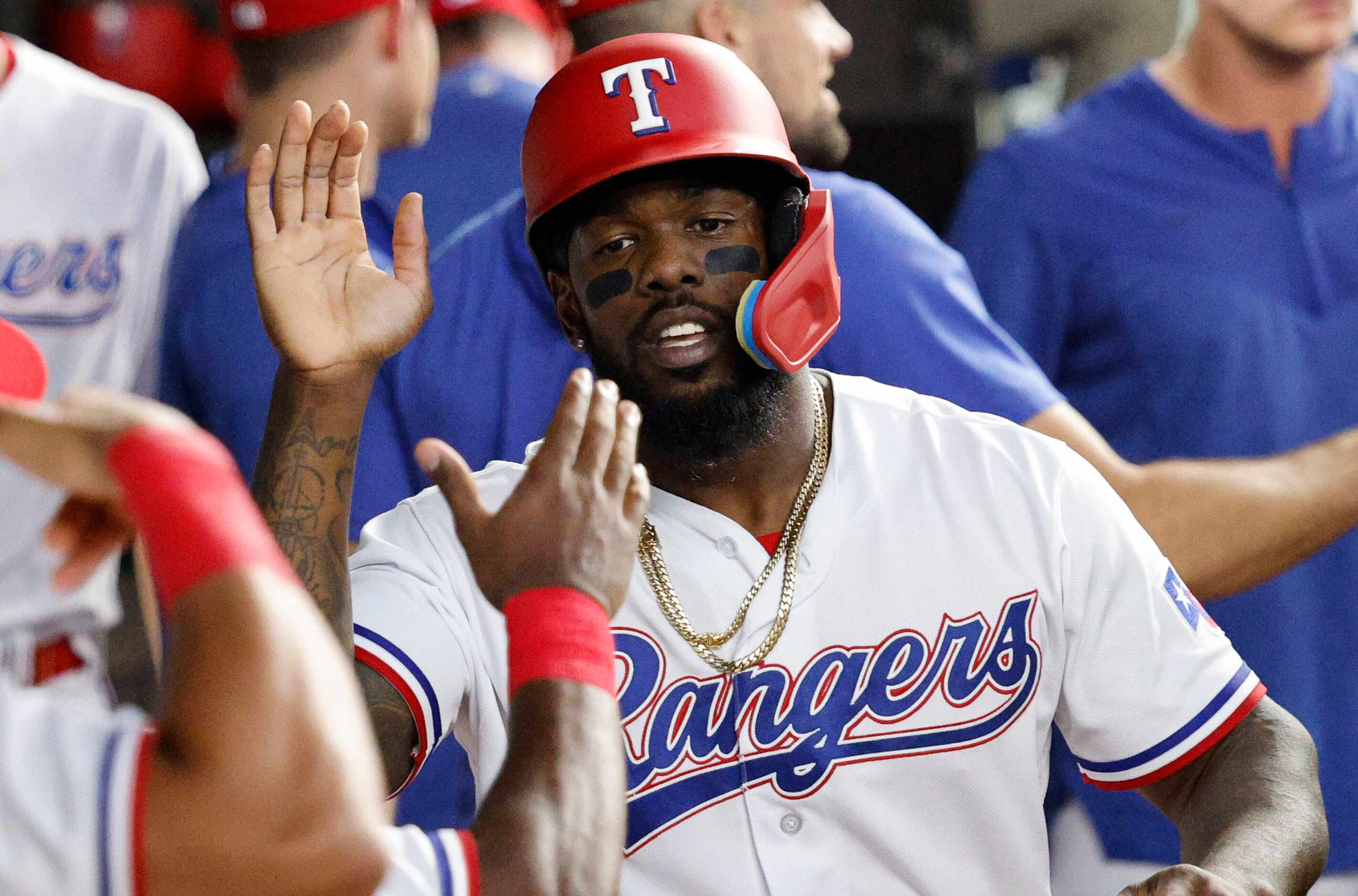 Texas Rangers right fielder Adolis Garcia (53) gets a high-five from his teammate after...