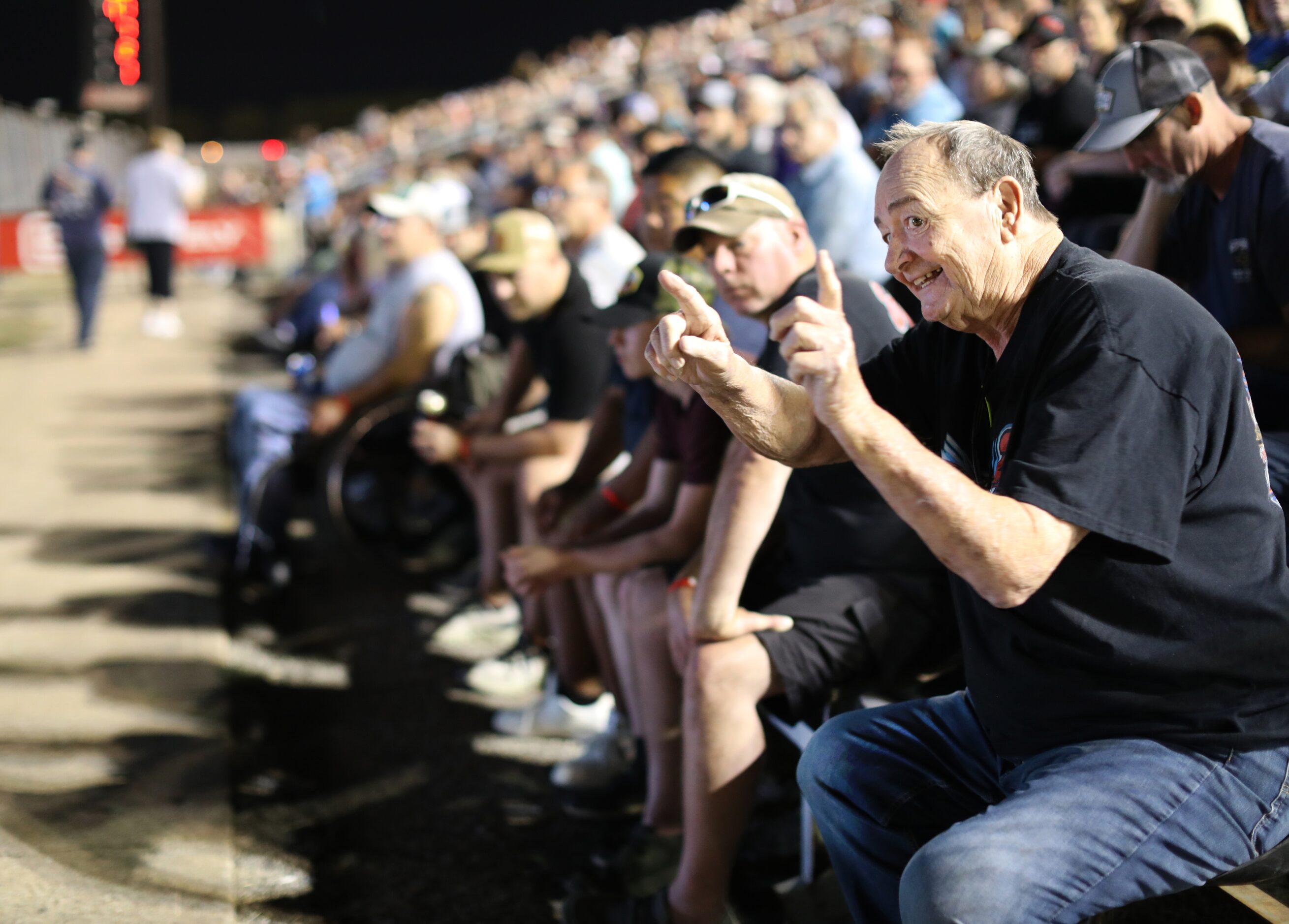 Ferris Bavousett, right, who has been attending races at Devil's Bowl for 25 years, cheers...