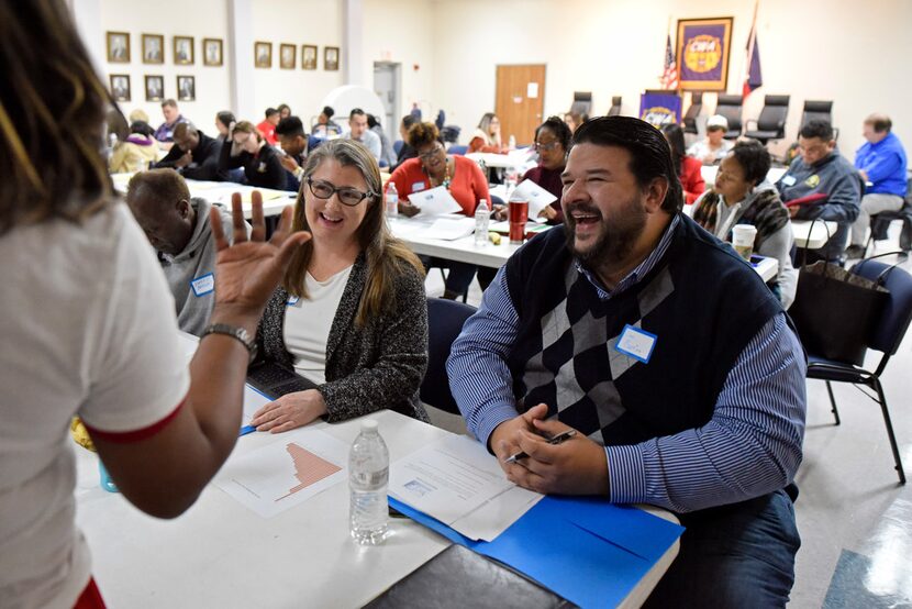 Volunteer Pam Thompson (left) and candidate Dan Barrios, both of Richardson, speak with an...