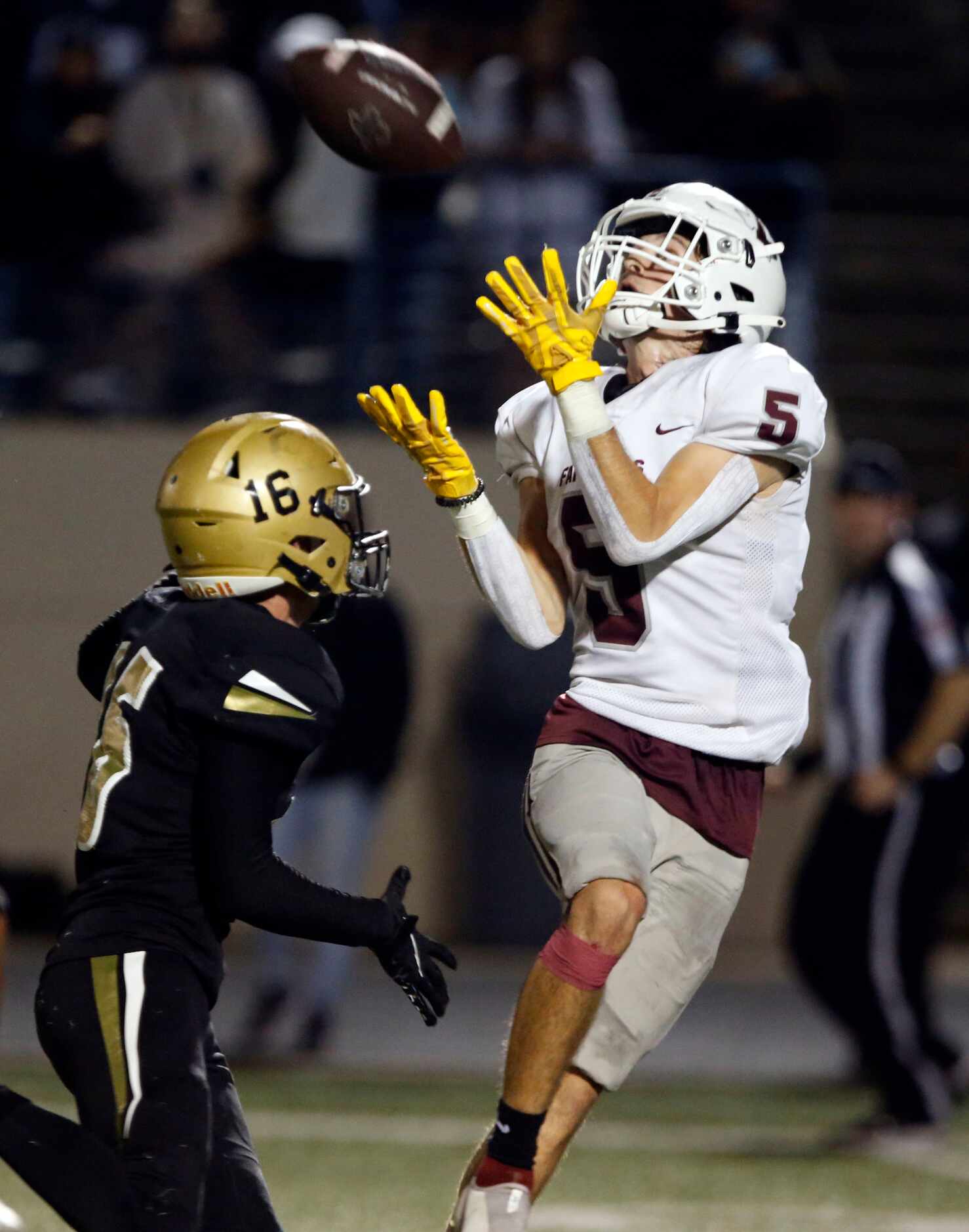 LewisvilleWR Brent Allen (5) catches a touchdown pass over Plano East defender Holden Stokes...