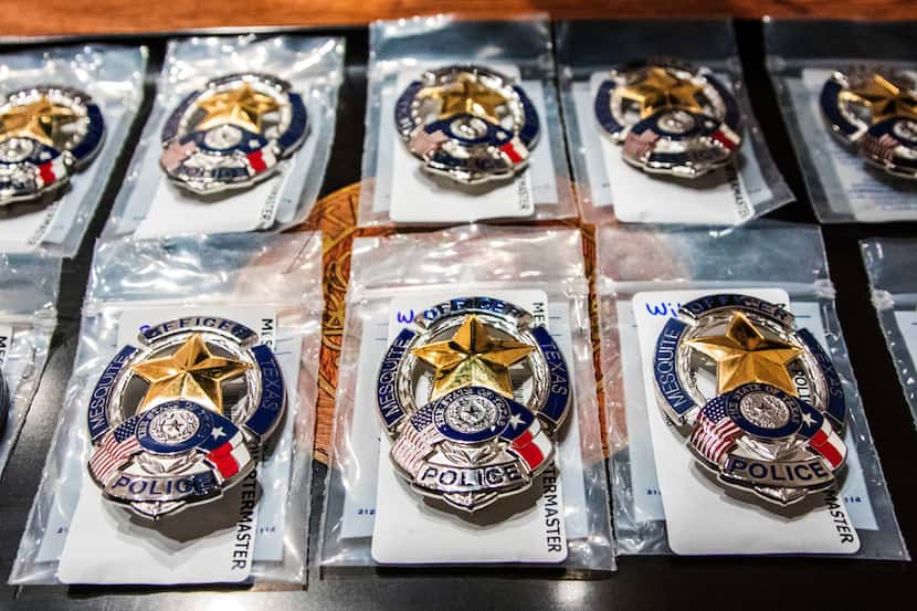 Police badges before getting pinned on uniforms during graduation from Mesquite police...