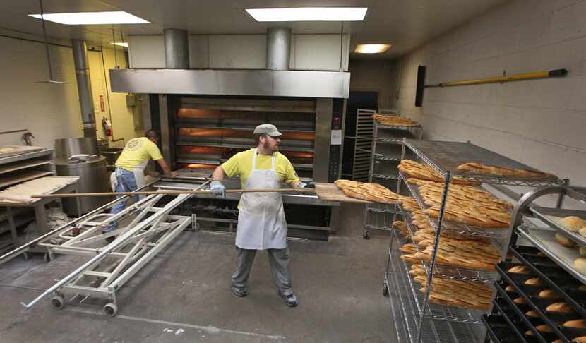 Fidel Morales Cisneros (left) and Jonathan Brown make long, narrow loaves of French bread...