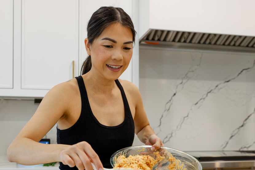 Alissa Nguyen puts a mix of salmon, imitation crab with spicy mayo on top of rice.