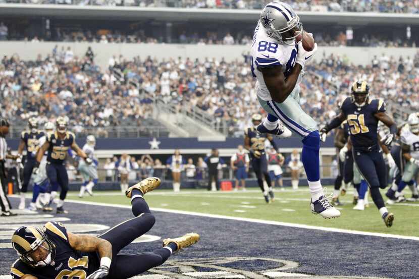 Dallas Cowboys wide receiver Dez Bryant (88) reaches up for the ball as he catches a...