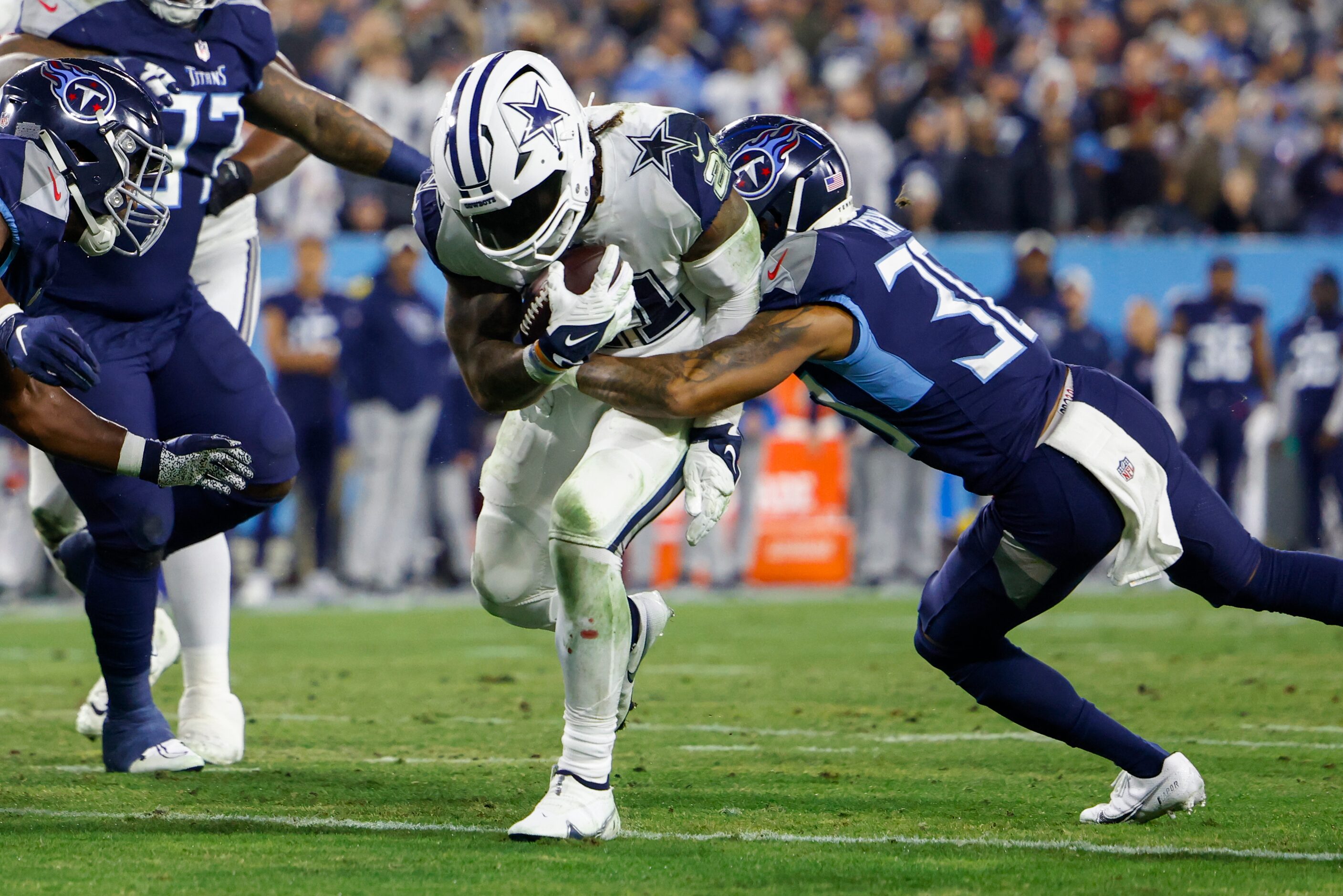 Tennessee Titans cornerback Tre Avery (30) tackles Dallas Cowboys running back Ezekiel...