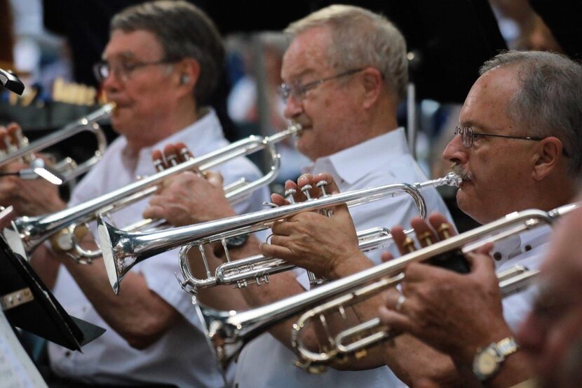 Tom Woody (right), former band director at Thomas Jefferson High School in Dallas, plays in...