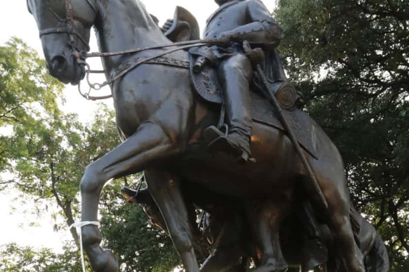 Dallas activist tie pictures of abolitionists to the statue of Robert E. Lee at Lee Park in...