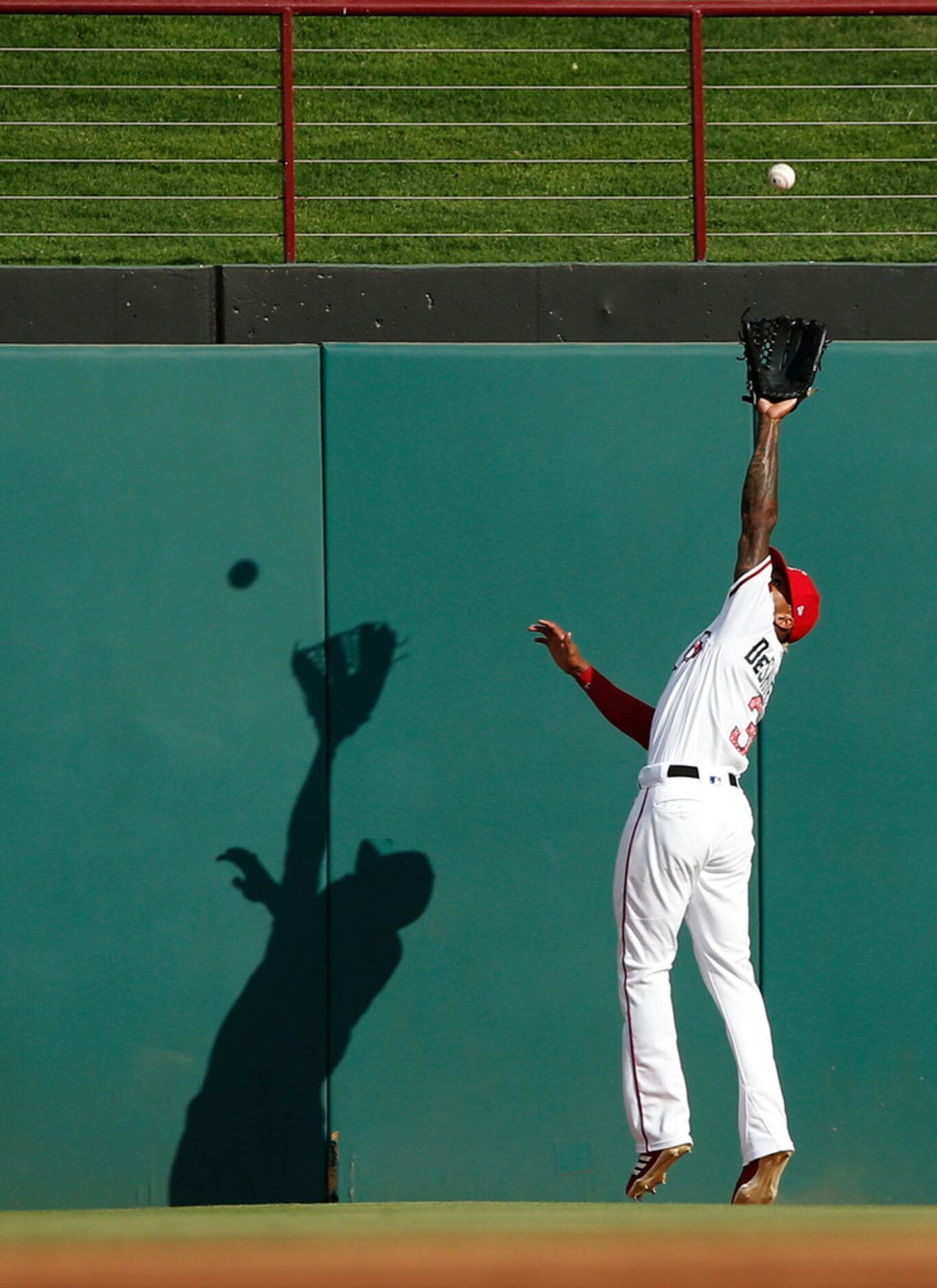 Texas Rangers center fielder Delino DeShields catches a fly-out hit by Houston Astros' Jose...