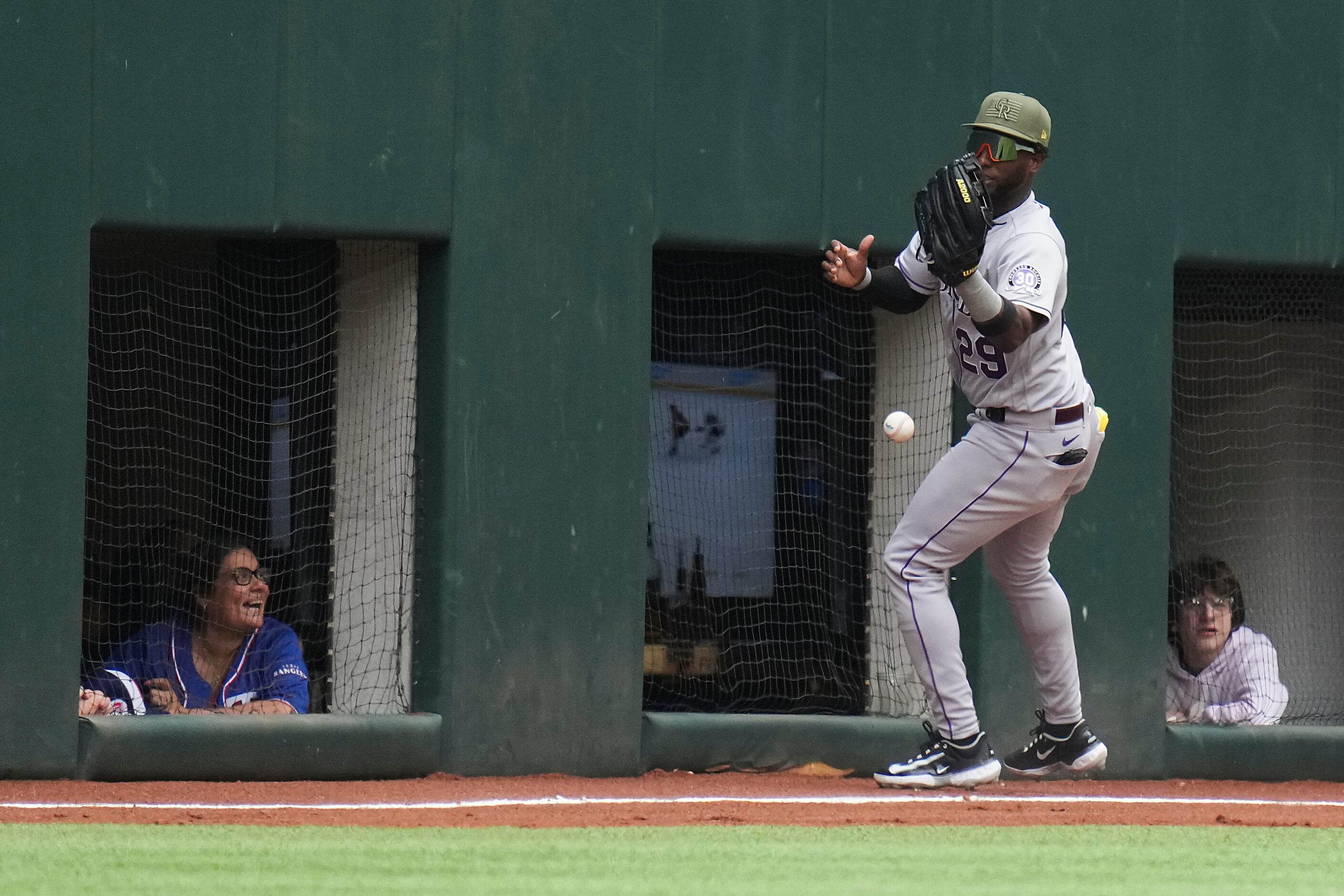 Colorado Rockies left fielder Jurickson Profar chases the ball into the corner on a...