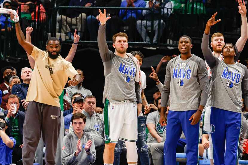 Dallas Mavericks guard Luka Doncic (77) celebrates with his team a three-pointer during the...