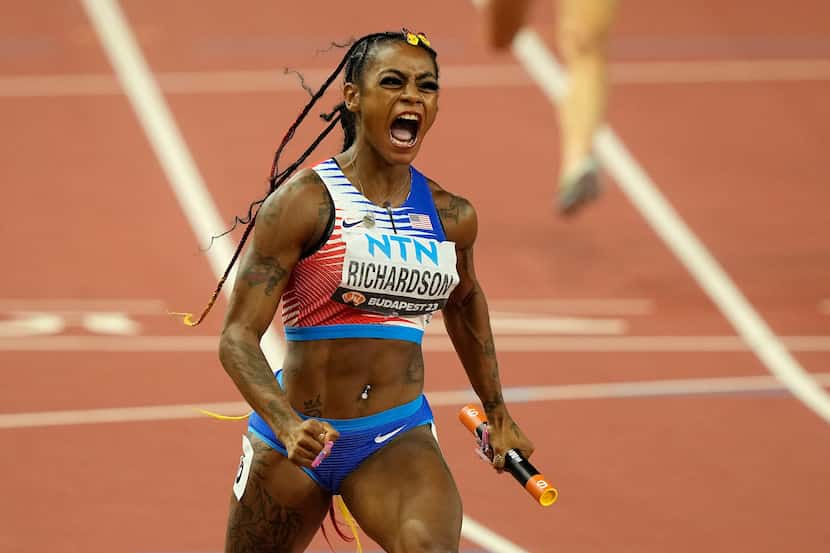 Sha'Carri Richardson, of the United States, celebrates after she crosses the finish line to...