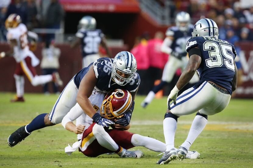 Dallas Cowboys defensive tackle David Irving (95) tackles Washington Redskins quarterback...