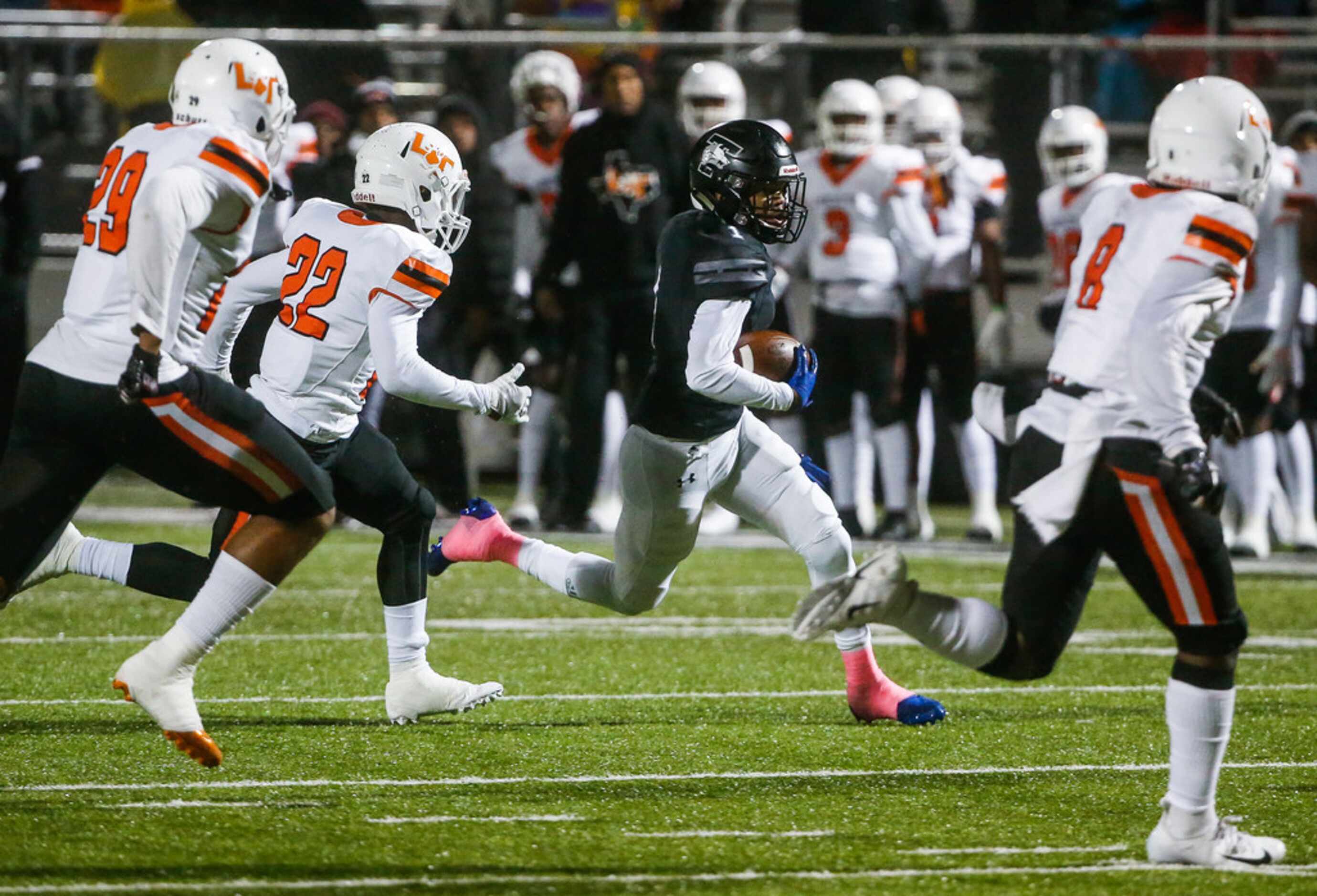 Mansfield Timberview running back Stacy Sneed (1) scrambles through a swarm of Lancaster...
