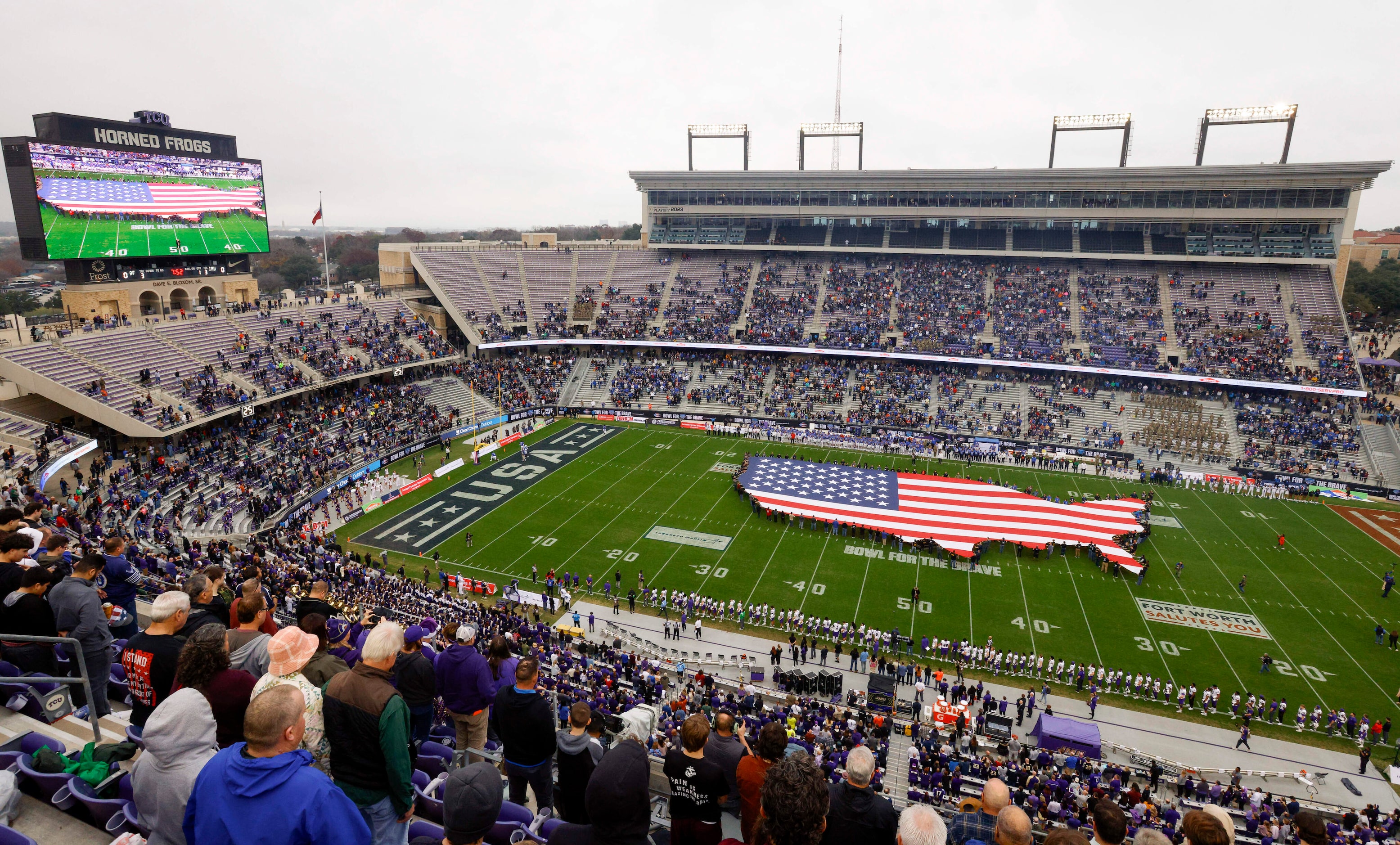 Fans stand for the national anthem before the first half of the Armed Forces Bowl NCAA...