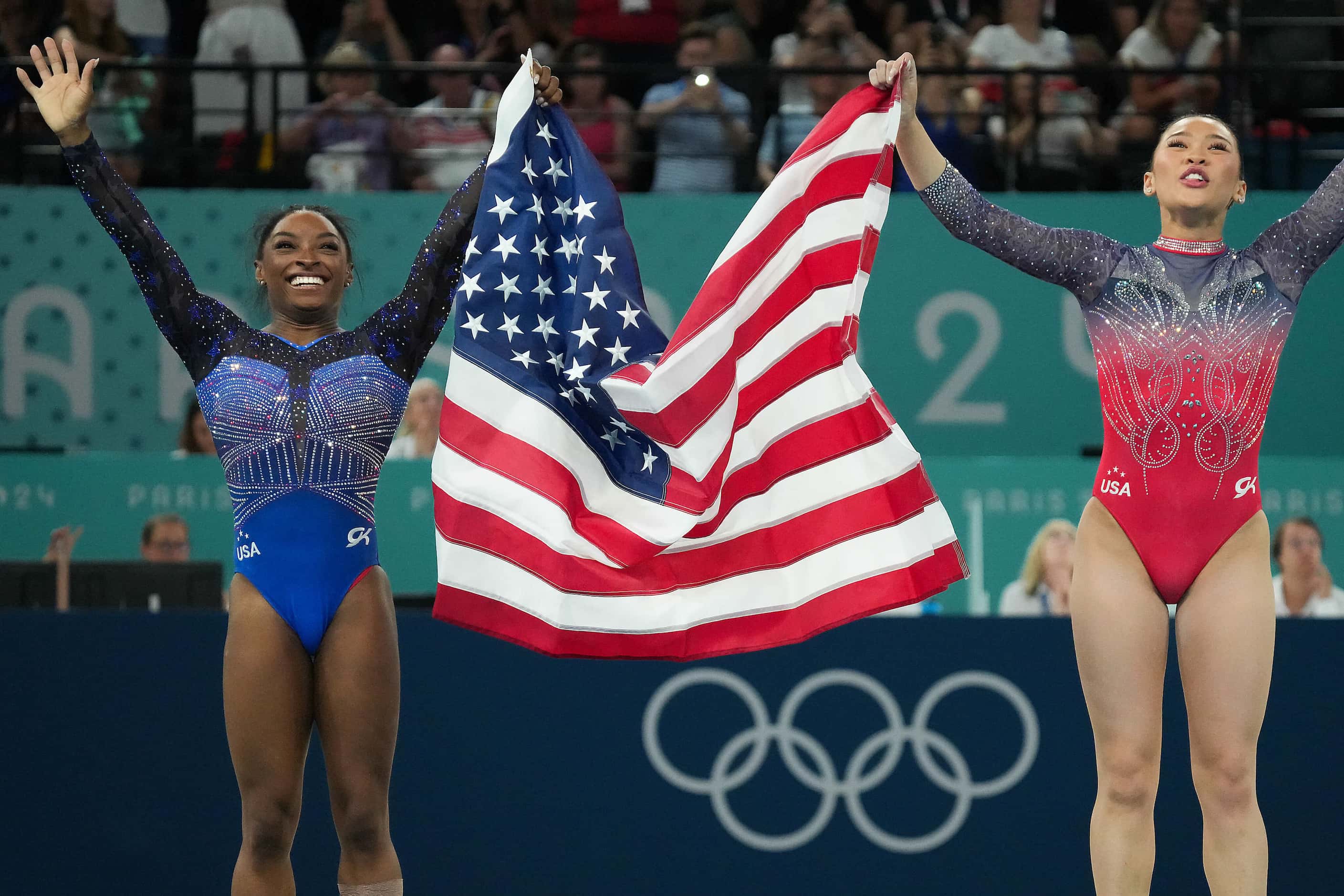 Simone Biles (leftI and Suni Lee of the United States celebrate after winning the gold and...