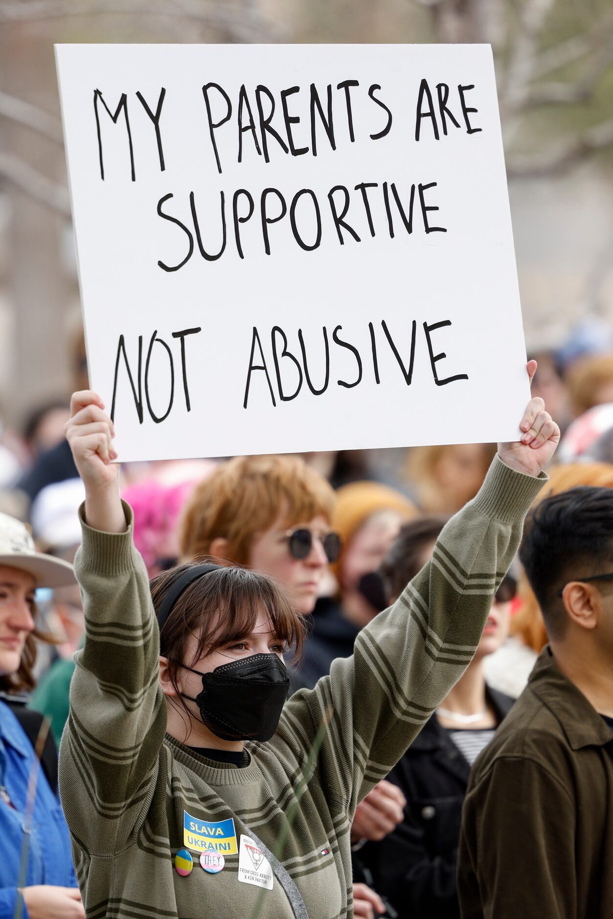 Ghost Niedzialkowski, 14, raises a sign during the "Trans Kids Cry For Help" rally outside...