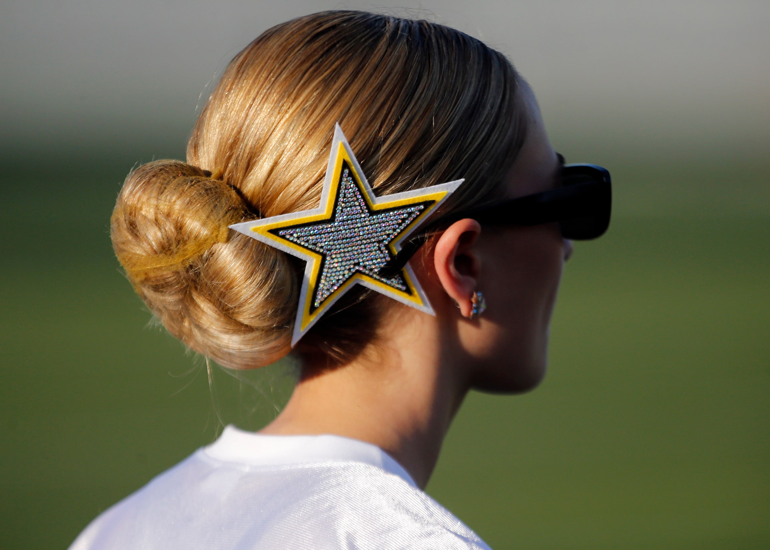 A Forney Highstepper drill teamer sports a star in her hair  before first half of a high...