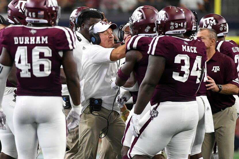 Texas A&M head coach Jimbo Fisher tries to calm his players after tempers flared on the...