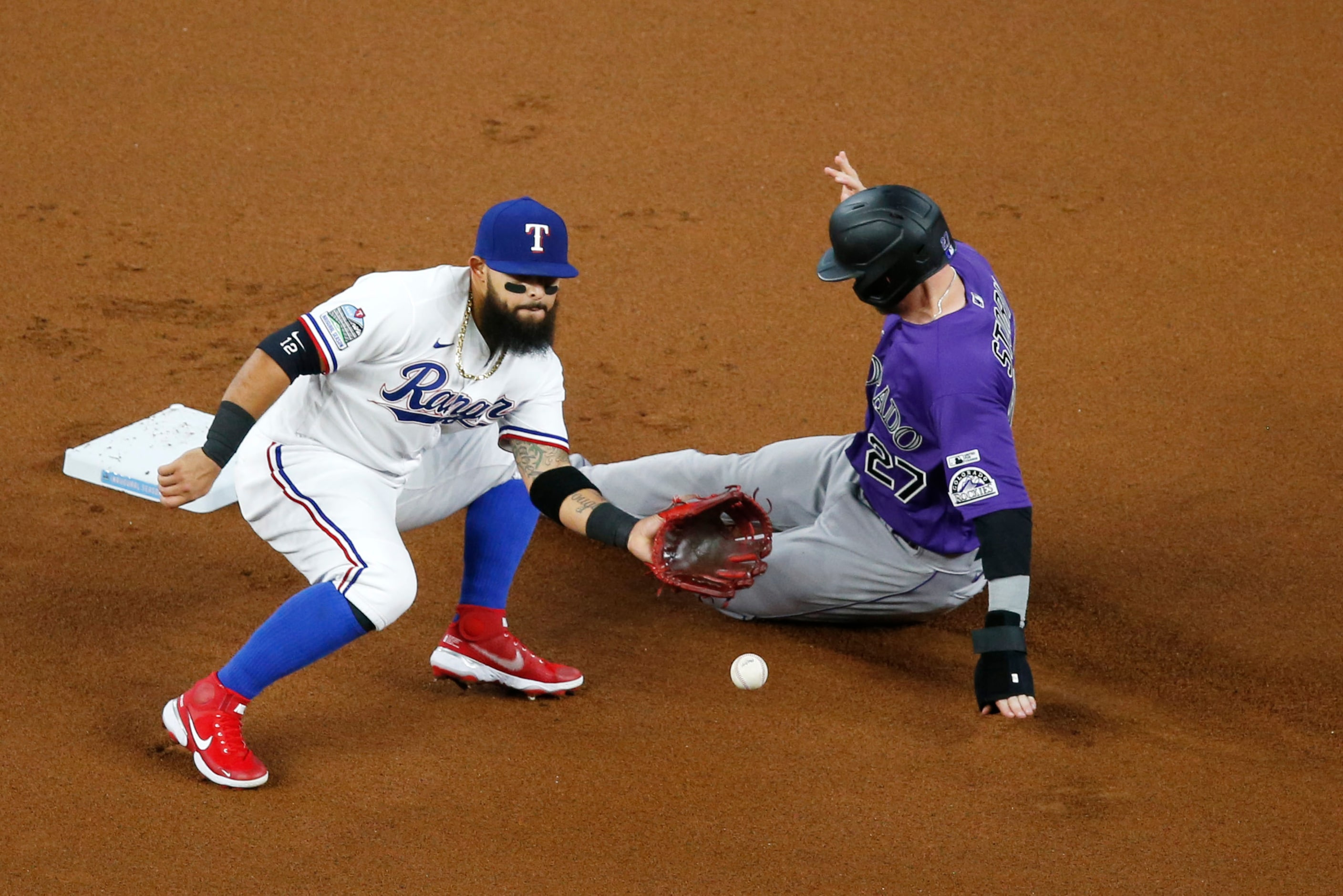 Colorado Rockies shortstop Trevor Story (27) steals second base as Texas Rangers second...