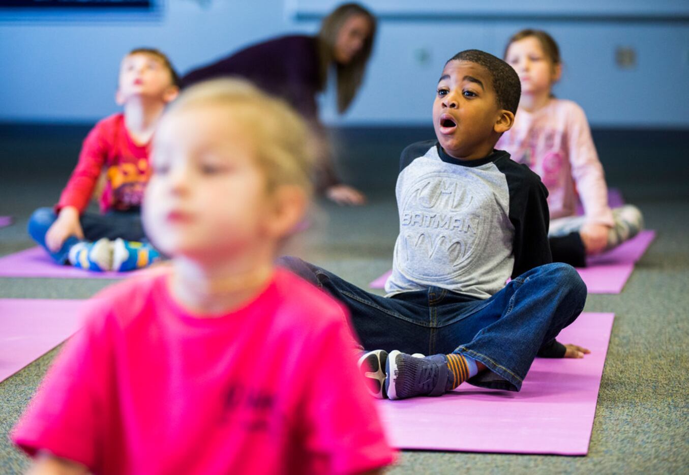 Elijah Curley (center) takes a deep breath while he and his kindergarten classmates practice...