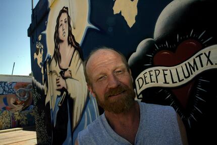 Artist Frank Campagna poses next to his large mural, painted in 2002 at the north entrance...