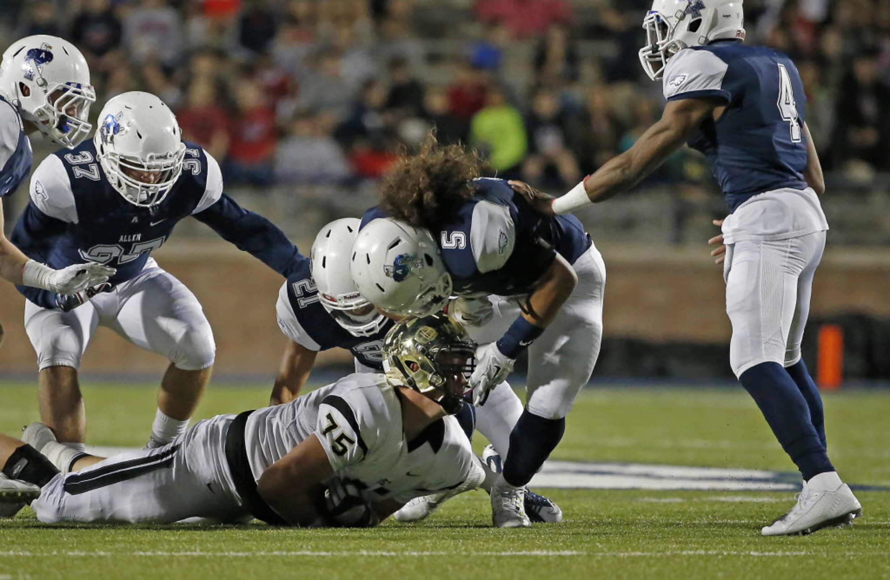 Plano East's Casey Verhulst (75) recovers a Plano East's fumble as he gets a face-mask by...