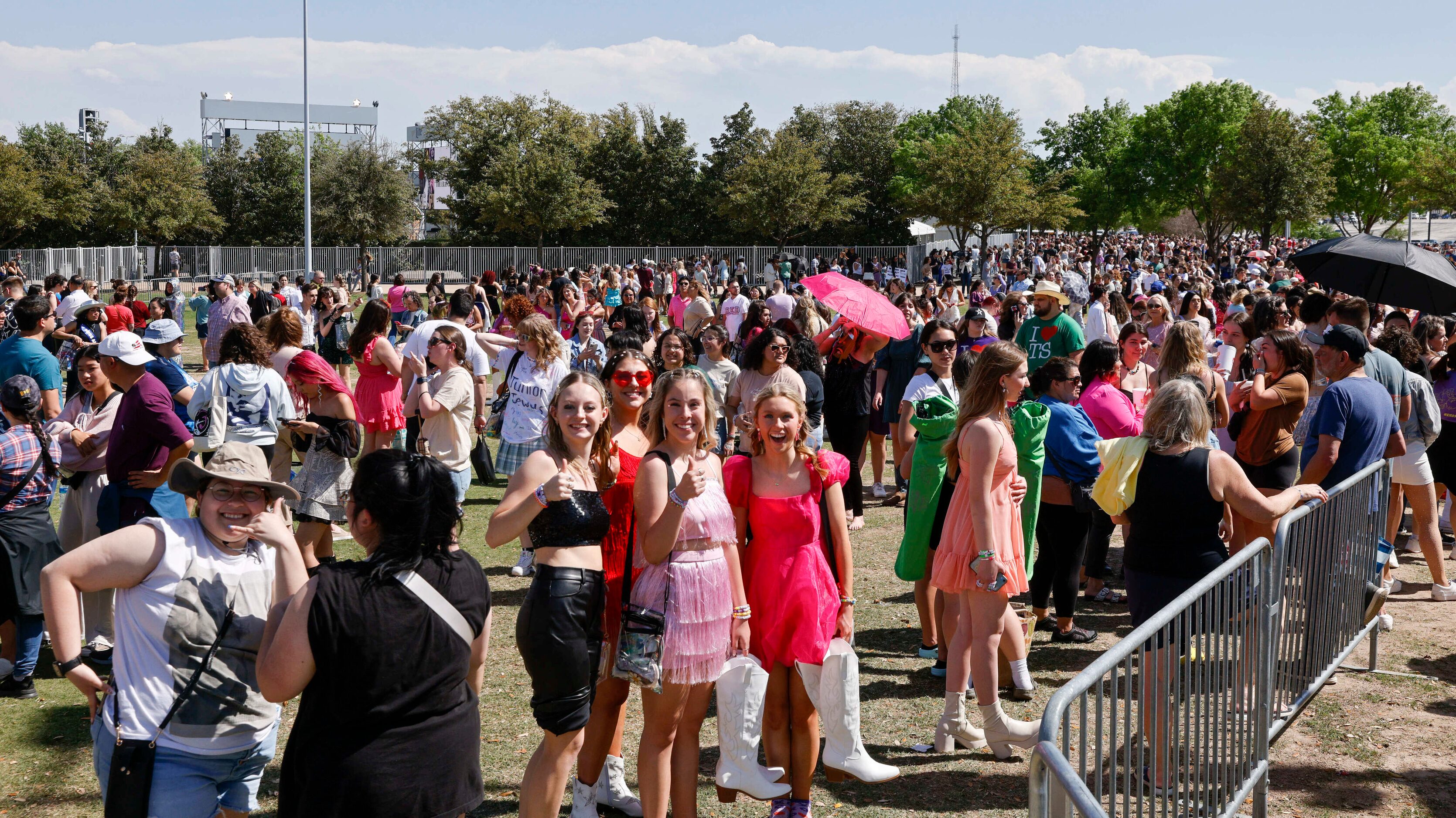 Fans wait in line to buy merchandise before a Taylor Swift Eras Tour concert at AT&T Stadium...