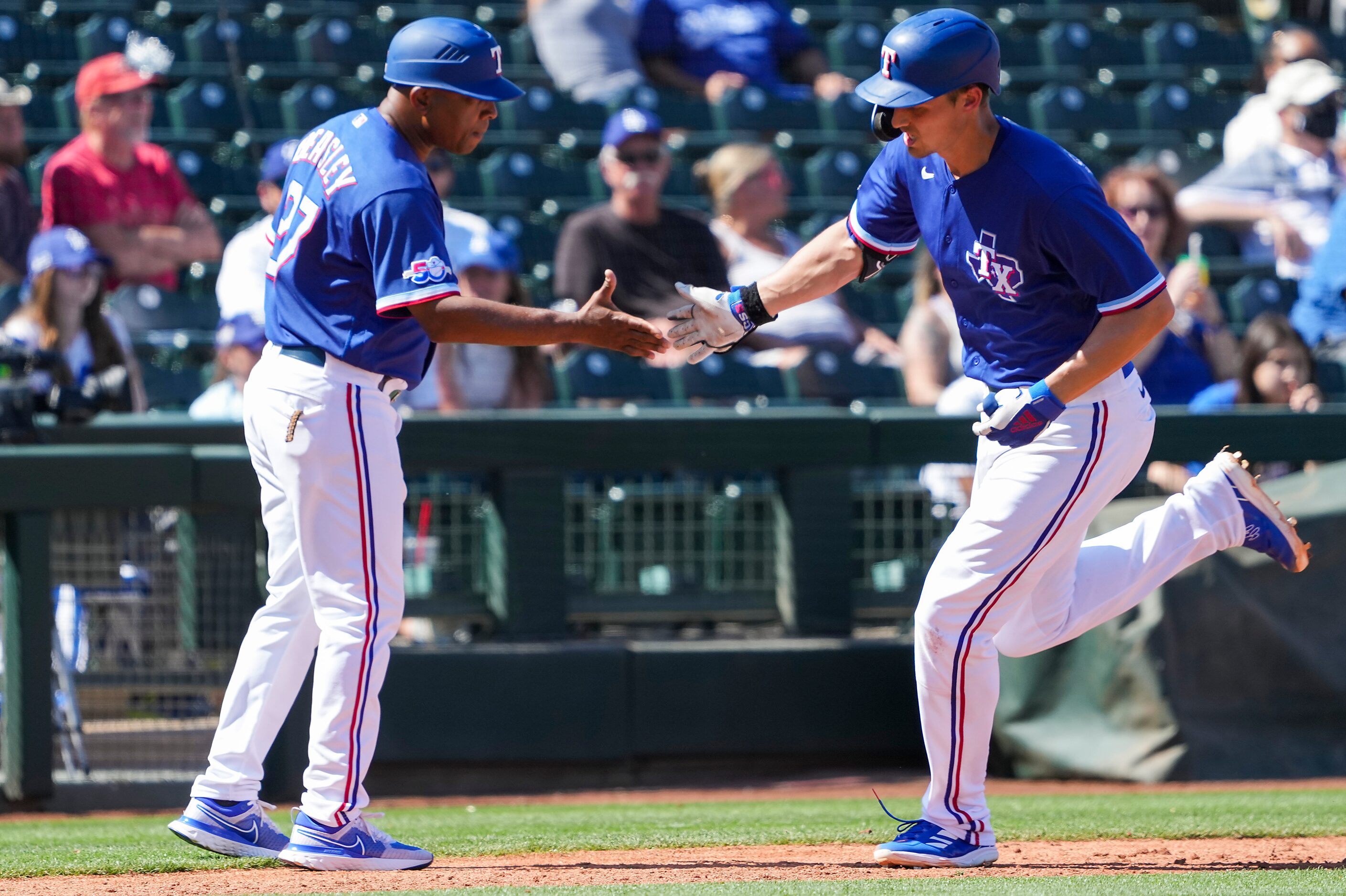 Texas Rangers shortstop Corey Seager celebrates with third base coach Tony Beasley after...