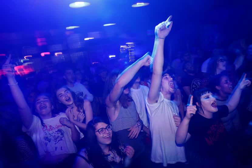 The crowd cheers as the emo band Microwave performs at the Dirty 30, a music club and bar in...
